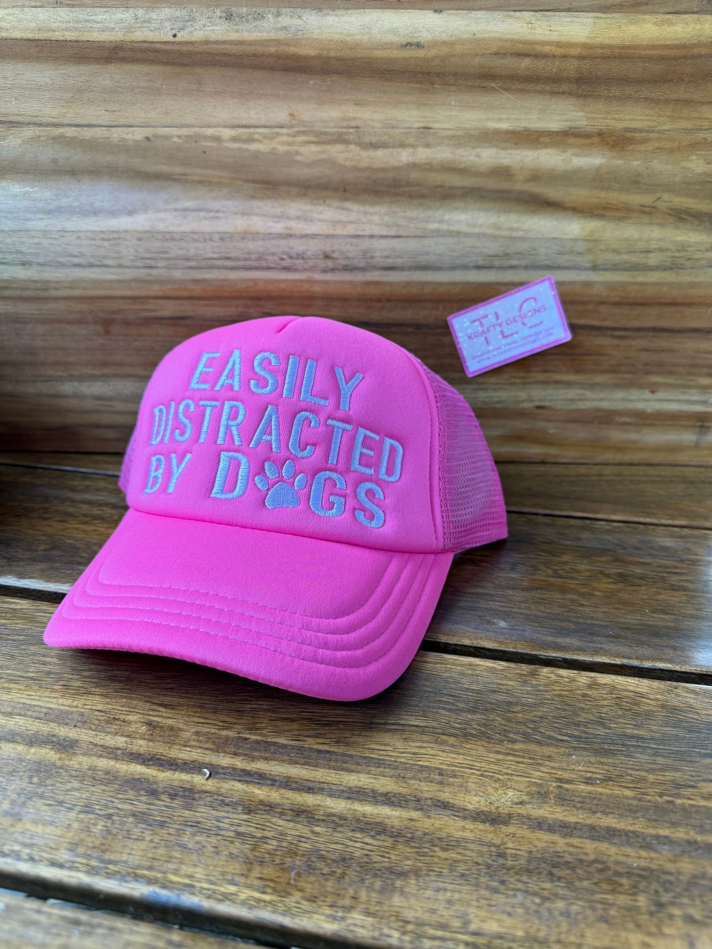 Easily Distracted by Dogs Trucker Hat – Bright Pink with Blue Text and Paw Accent