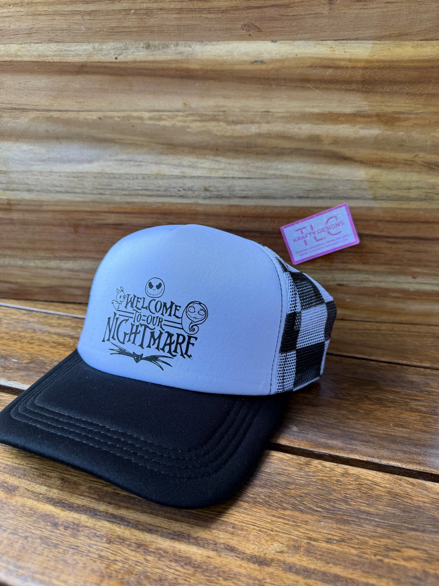 Welcome to Our Nightmare Trucker Hat – Black & White Checkered Mesh with Spooky Script