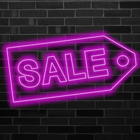 Neon 'SALE' sign on a brick wall background