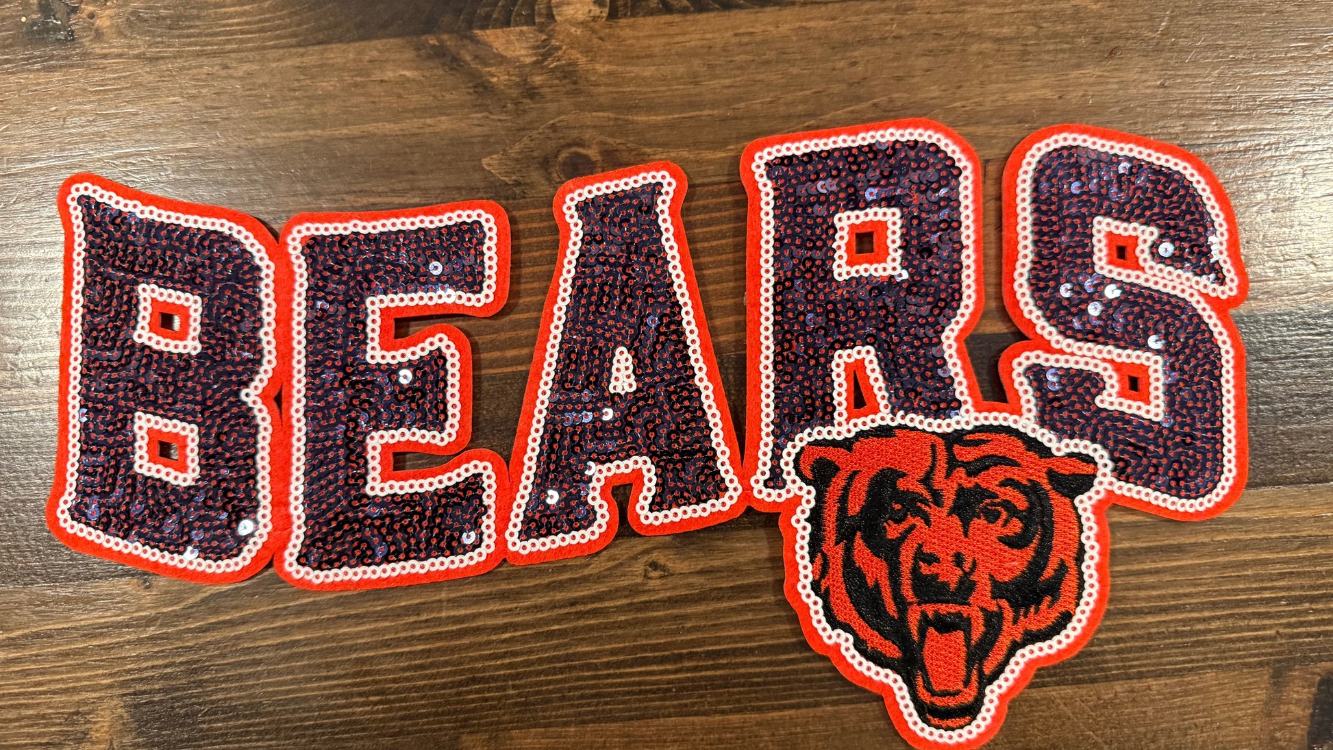 Decorative patch with 'BEARS' text and bear logo on a wooden surface