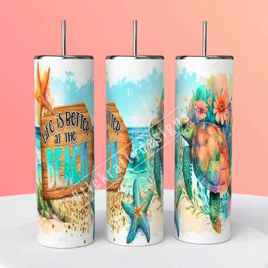 Charming sublimation 20oz. Skinny tumbler adorned with the whimsical phrase "Life is better at the beach,"