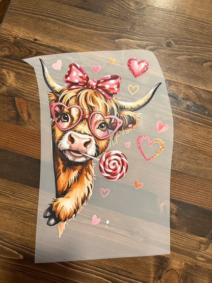 Cartoon cow with decorative elements on a wooden surface