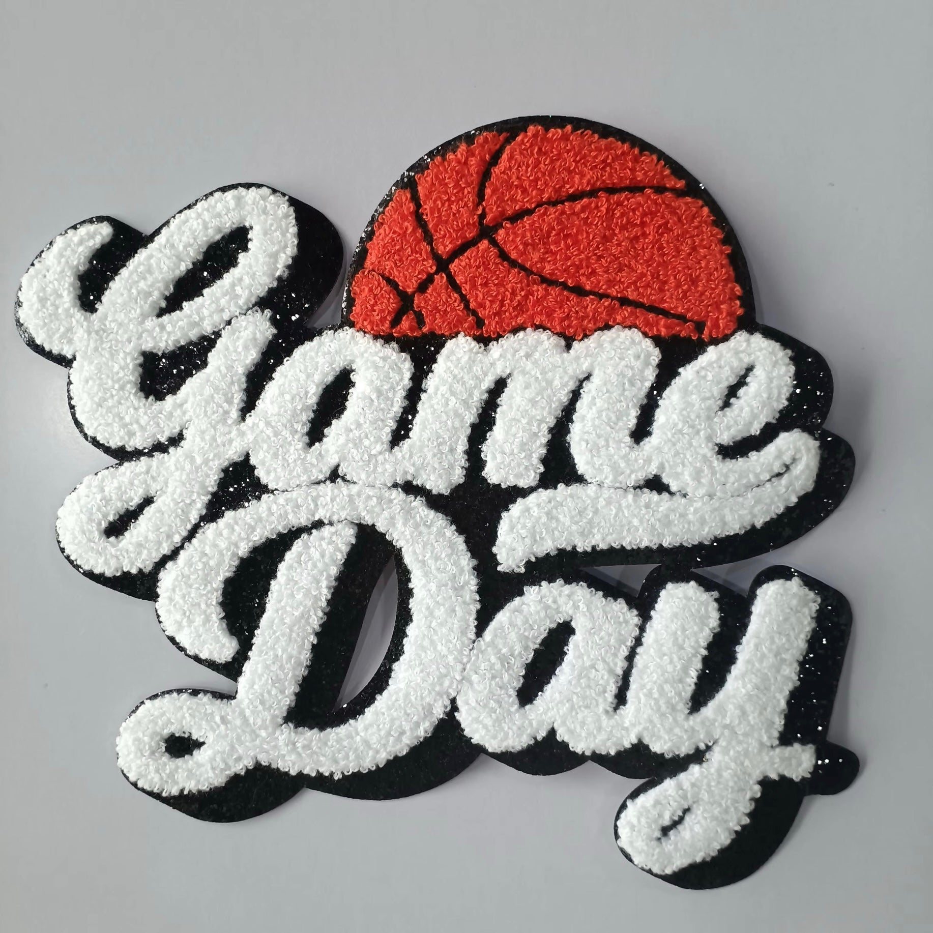 Embroidered patch with 'Game Day' text and a basketball on a gray background