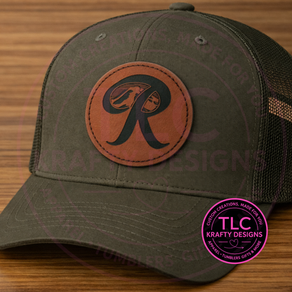 Green cap with brow leather patch featuring a letter 'R' on a wooden surface, with TLC Krafty Designs logo.