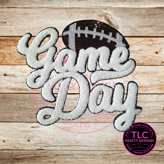 Embroidered patch with 'Game Day' text and football design on a wooden background, featuring TLC Krafty Designs logo.