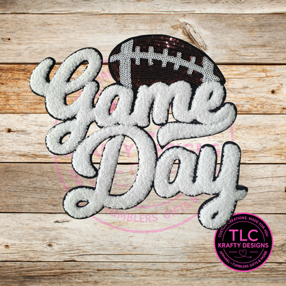 Embroidered patch with 'Game Day' text and football design on a wooden background, featuring TLC Krafty Designs logo.