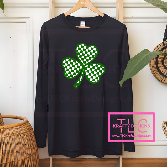 Black long-sleeve shirt with green checkered shamrock design on a hanger, brand 'TLC KRAFTY DESIGNS' visible.