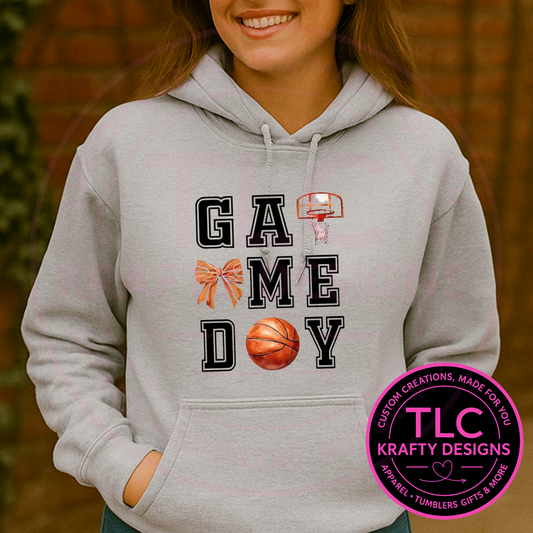 Person wearing a gray hoodie with 'Game Day' and sports-themed design, with TLC Krafty Designs logo.