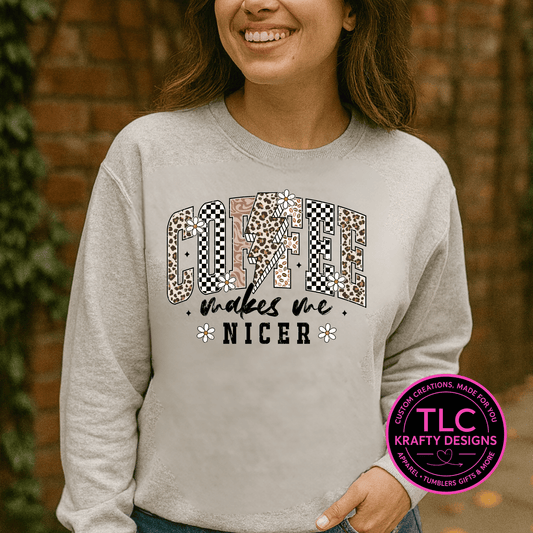 Person wearing a gray sweatshirt with a colorful graphic and text, standing against a brick wall.