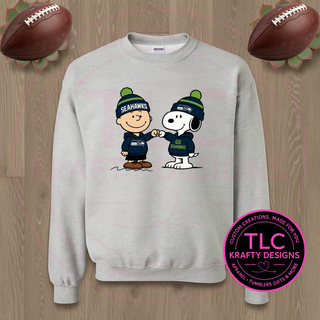 Gray sweatshirt with cartoon characters wearing Seahawks hats on a wooden background, featuring TLC Krafty Designs logo.