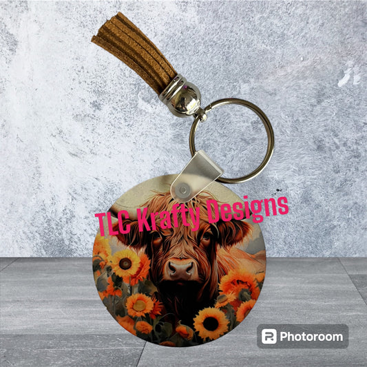 Highland Cow surrounded by a bed of flowers Keychain with Tassel