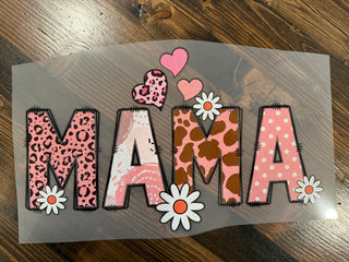 Decorative sign with 'MAMA' in leopard print, polka dot, and floral designs on a wooden surface.