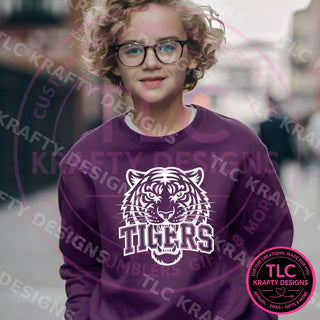 Young boy wearing a purple Tigers crewneck