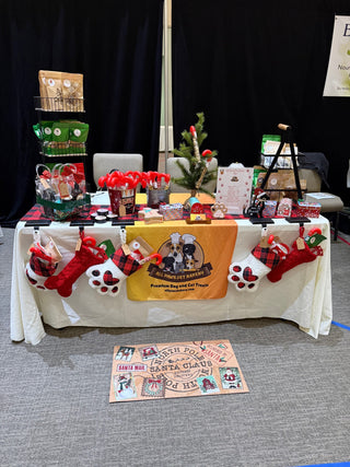 The All Paws Pet Bakery booth with stuffed pet stockings, treat bags and candy cane treat tubes