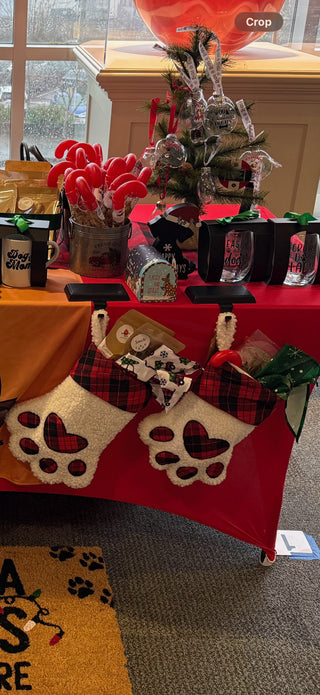 Stuffed All Paws Pet Bakery dog stockings — sherpa paw stockings with plaid cuffs, filled with treats