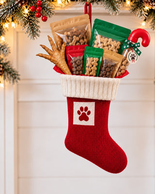 Knitted Paw Print stocking stuffed with All Paws Pet Bakery treats
