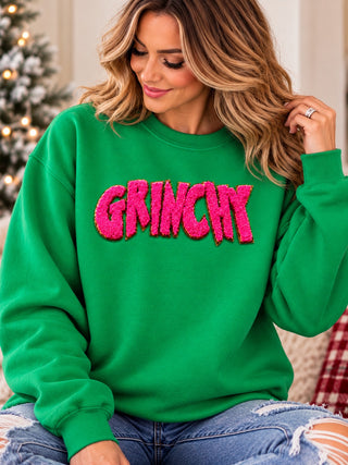 Green Man chenille patch in pink on green crewneck sweatshirt