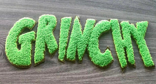 Green chenille patch close-up with gold glitter trim