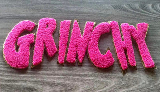 Pink chenille patch close-up with gold glitter trim